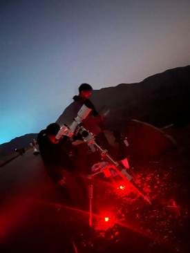 A person standing in front of a red light
AI-generated content may be incorrect.